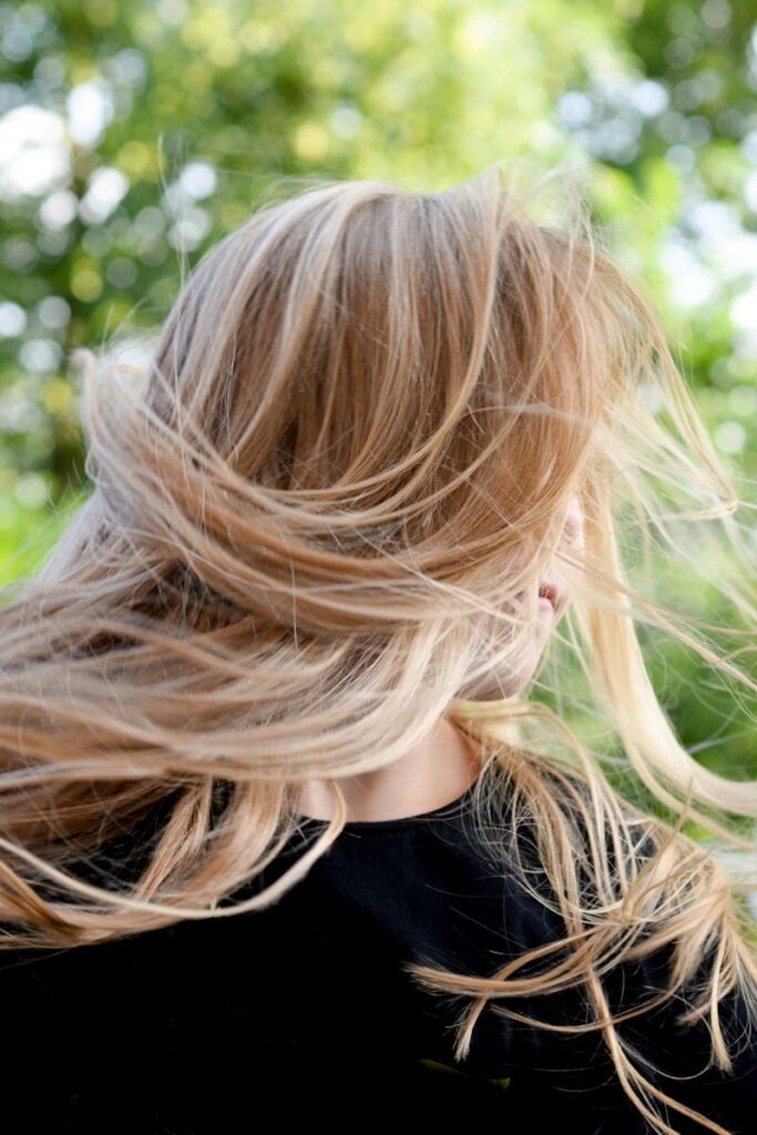 pexels-photo-1708763-1708763 Blonde woman outside with hair blowing in the wind on a sunny summer day.