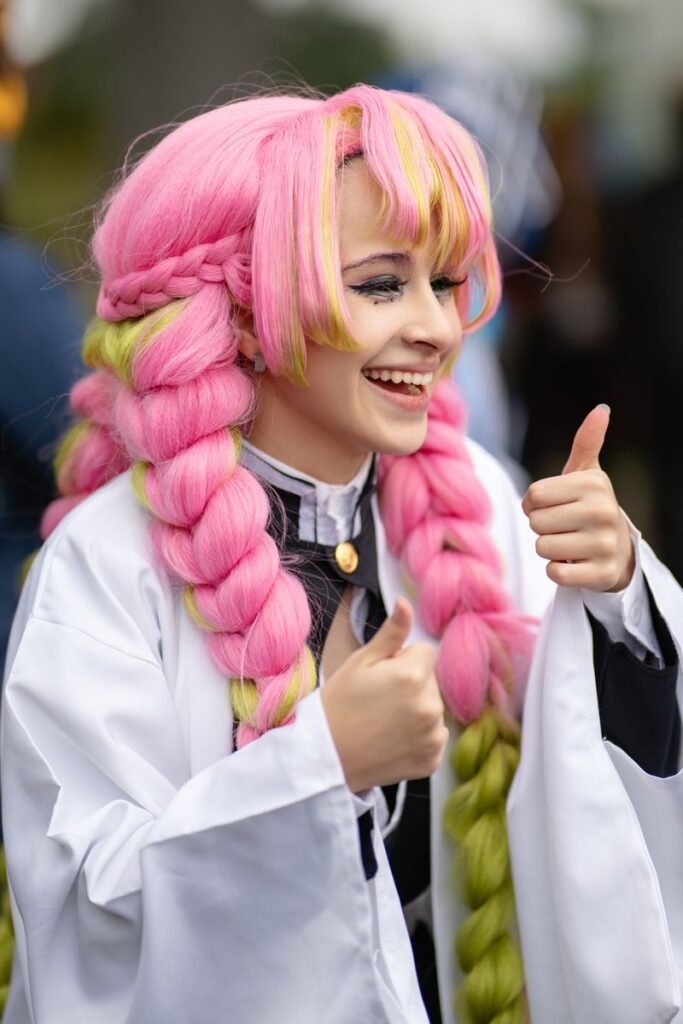 Cosplay enthusiast in vibrant pink wig and costume at an anime convention in San José, Costa Rica.