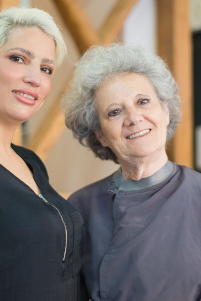 pexels-photo-8834052-8834052 Smiling hair stylist with a happy elderly client in a modern salon setting